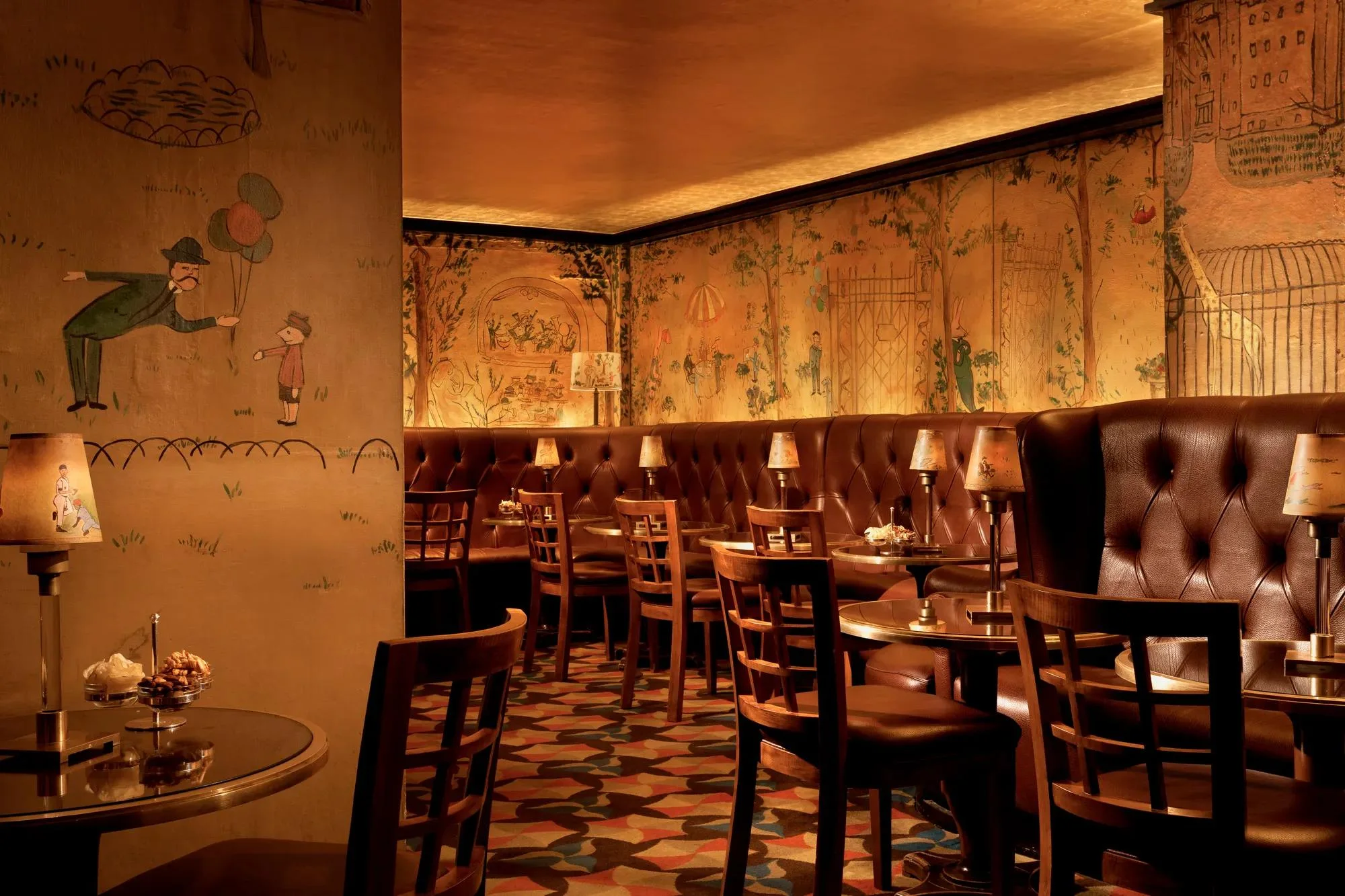 Leather banquettes beneath Ludwig Bemelmans’s murals at Bemelmans Bar in The Carlyle